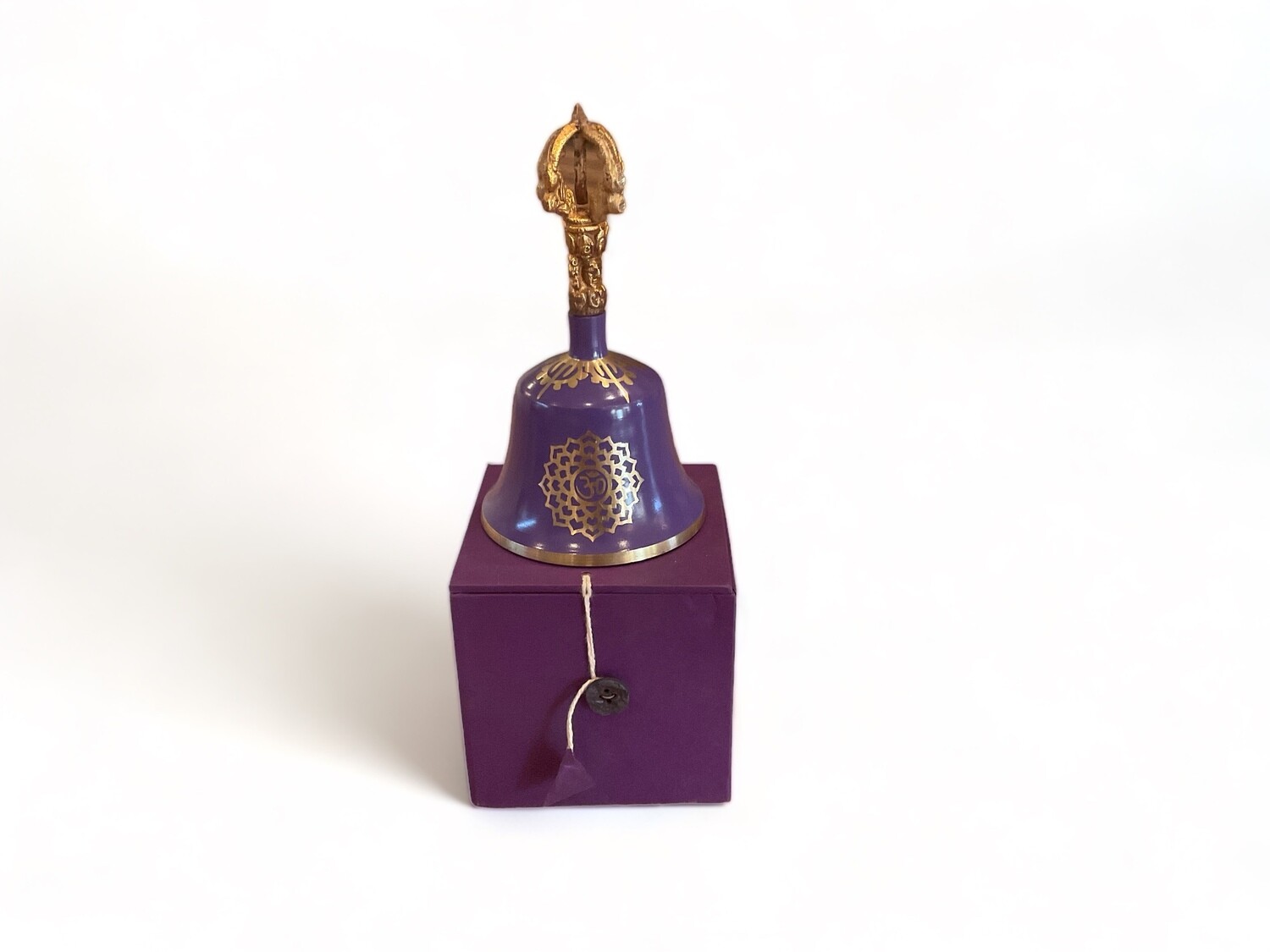 Image of a beautiful Violet Crown Chakra Tibetan Bell with a matching striker. The bell, 5.5 inches features a deep violet finish and intricate patterns. Designed to harmonize the seventh chakra, it produces a clear, resonant sound aimed at enhancing wisdom and collective consciousness.