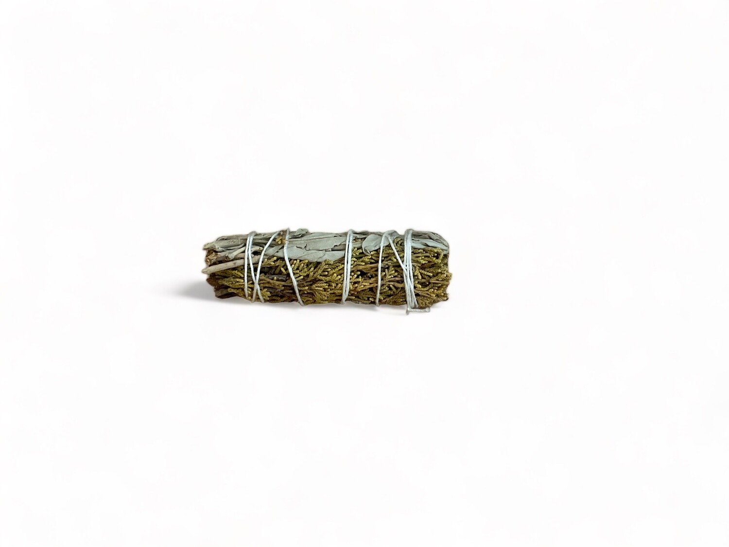 Photo of Juniper and Sage Bundle. A  four inch bundle consisting of white sage and juniper bound together with natural twine. This blend is used for energy cleansing, purification, protection, and healing. The bundle features a fragrant aroma ideal for enhancing spiritual practices and rituals.