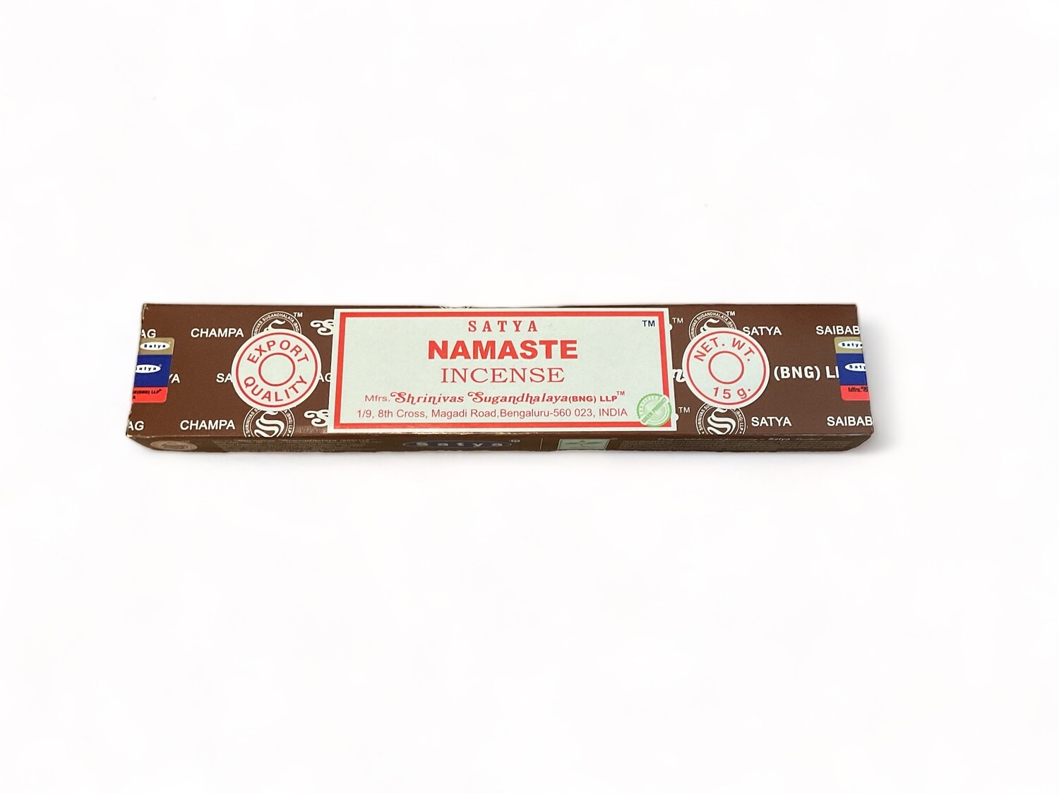 Image of a box containing 15 Namaste incense sticks. The packaging indicates that the sticks are hand-rolled by Shrinivas Sugandhalaya in India using high-quality pure extracts. The box details about the incense’s long-lasting, earthy scent. Each stick is designed to burn slowly and provide a rich, enduring aroma ideal for creating a tranquil atmosphere.