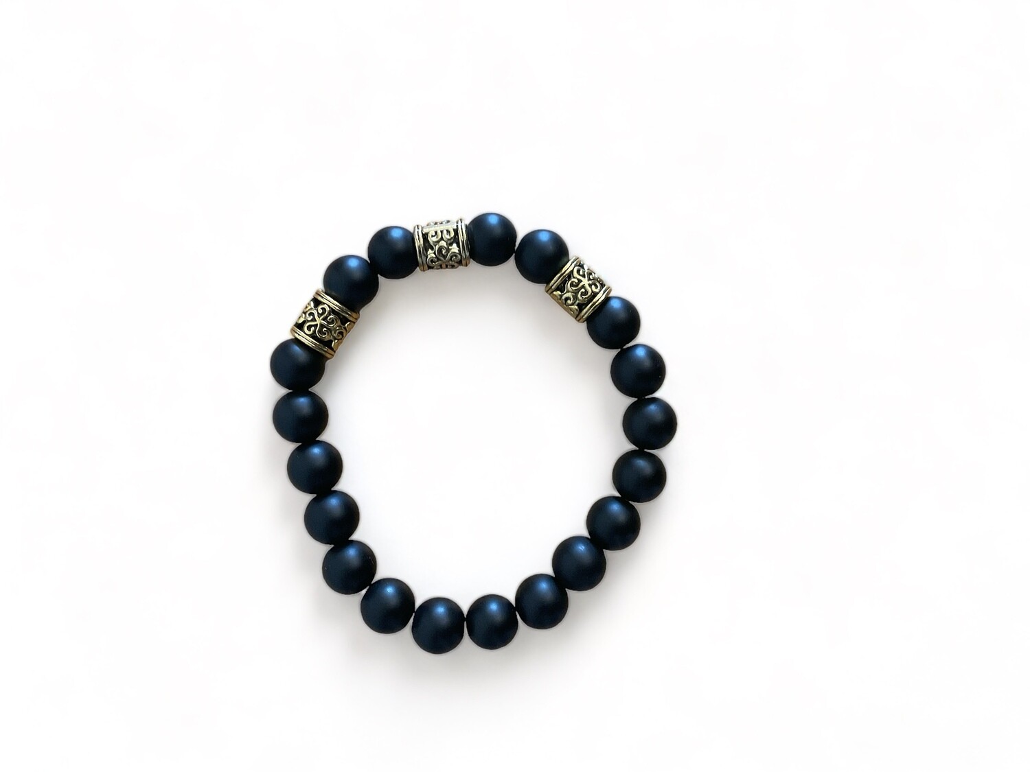 Close-up photo of a 10mm black matte agate bracelet with gold spacers, showcasing a chic design. The bracelet features smooth black stones interspersed with elegant gold accents, ideal for protection and spiritual grounding.