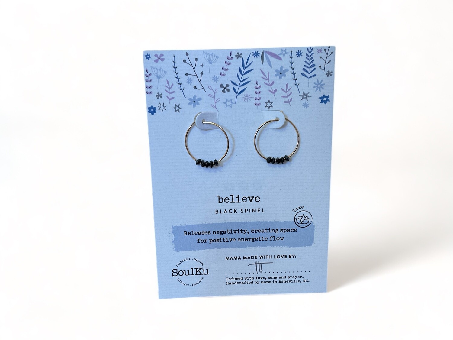Photo of gold hoop earrings featuring dark Spinel gemstones. These metaphysical earrings offer balance and timeless beauty.