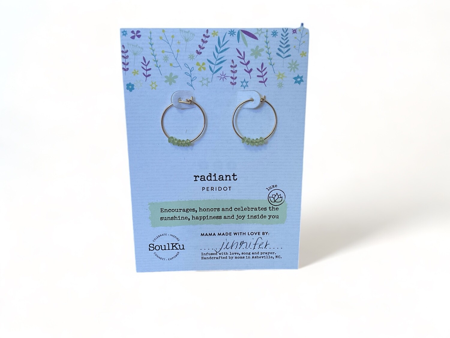 Image of golden hoop earrings with light green peridot gemstones. These chic earrings feature a classic design, known for their healing properties and refreshing color.