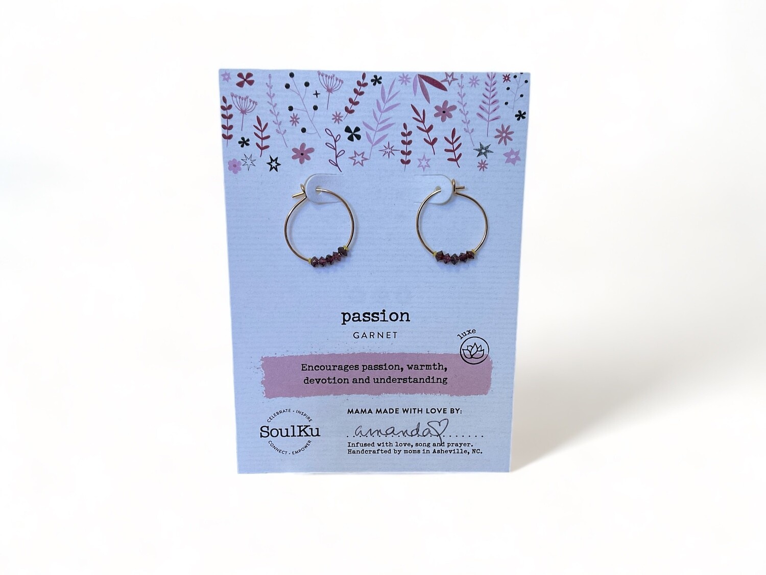 Photograph of gold hoop earrings set with deep red garnet crystals. The beautiful earrings feature a classic design, adding a rich splash of color to any jewelry collection.