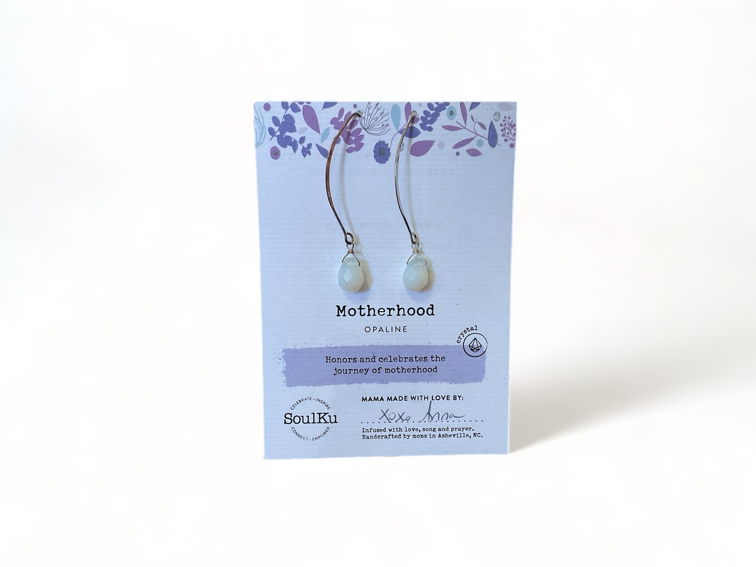 Image of long earrings with iridescent opaline gemstones, showcasing a milky, translucent glow. These earrings are crafted to support emotional healing, serenity, and balanced communication.