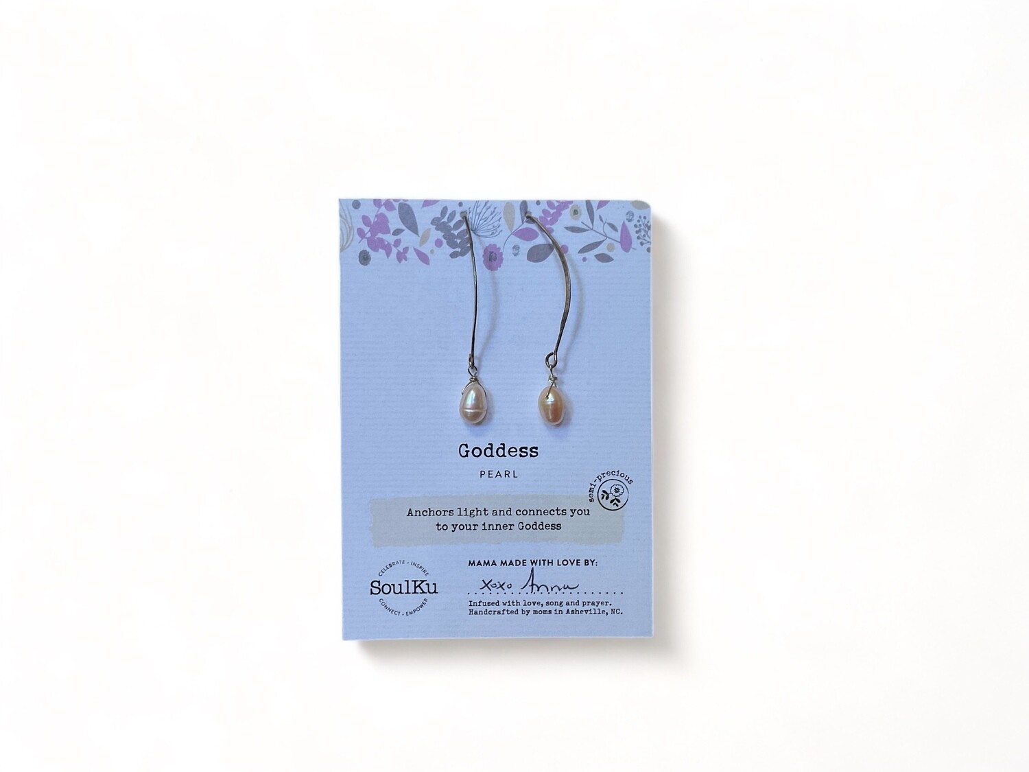 Image of long pearl earrings featuring smooth, lustrous pearls suspended from delicate golden hooks. Designed to evoke spiritual connection and inner strength. 