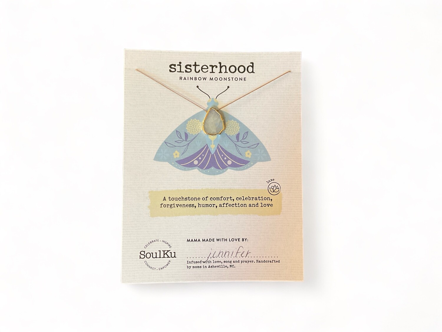 Photo of a Rainbow Moonstone crystal necklace with an iridescent pendant showing flashes of blue, green, yellow, and pink. This piece is designed to enhance intuition and emotional balance, making it a meaningful gift for sisterhood.