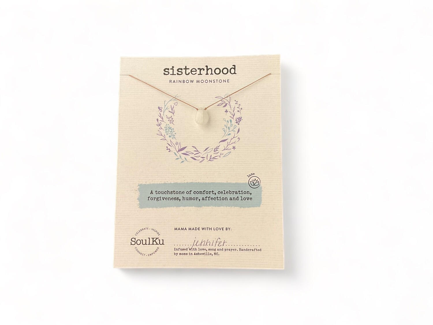 Photo of a Luxe Moonstone Necklace featuring a smooth, opalescent stone with a pearly sheen. The necklace&#39;s moonstone displays a shimmering, ethereal glow in shades of white and blue, symbolizing comfort and love.
