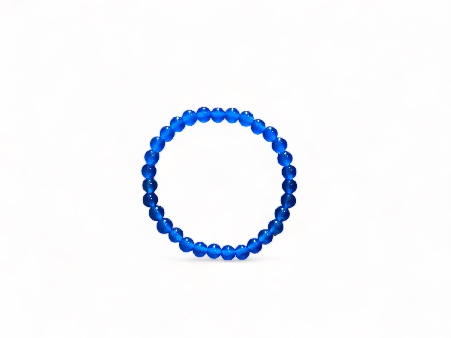 Photo of a 6mm Dark Blue Jade bracelet featuring cool hues. This smooth jadeite crystal bracelet is designed to promote calmness, clarity, and protection.
