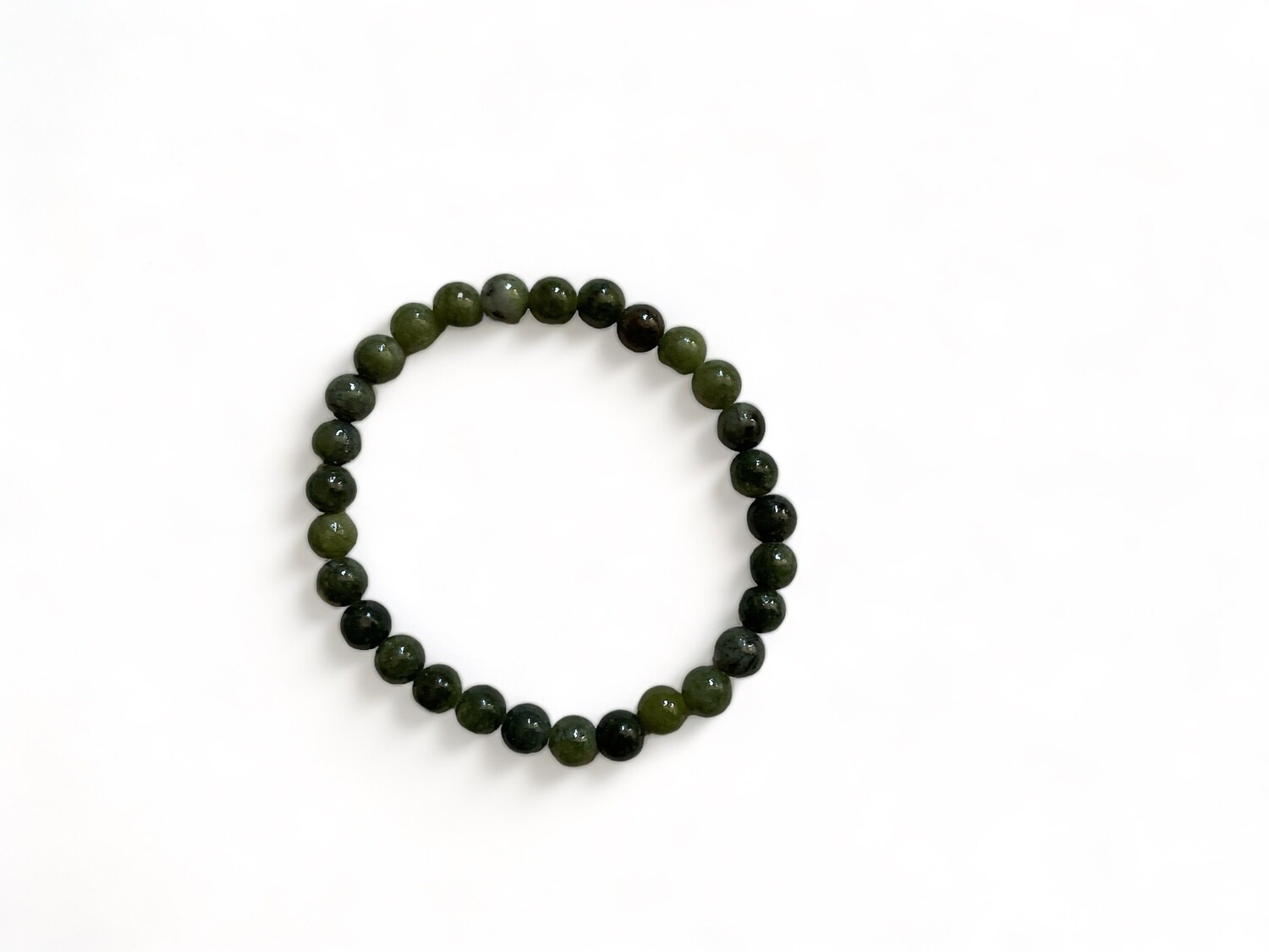Image of a Green Lace Agate Bracelet 6mm featuring dark green stones with delicate lacing patterns. This unique crystal bracelet is designed for emotional calm and transformation.