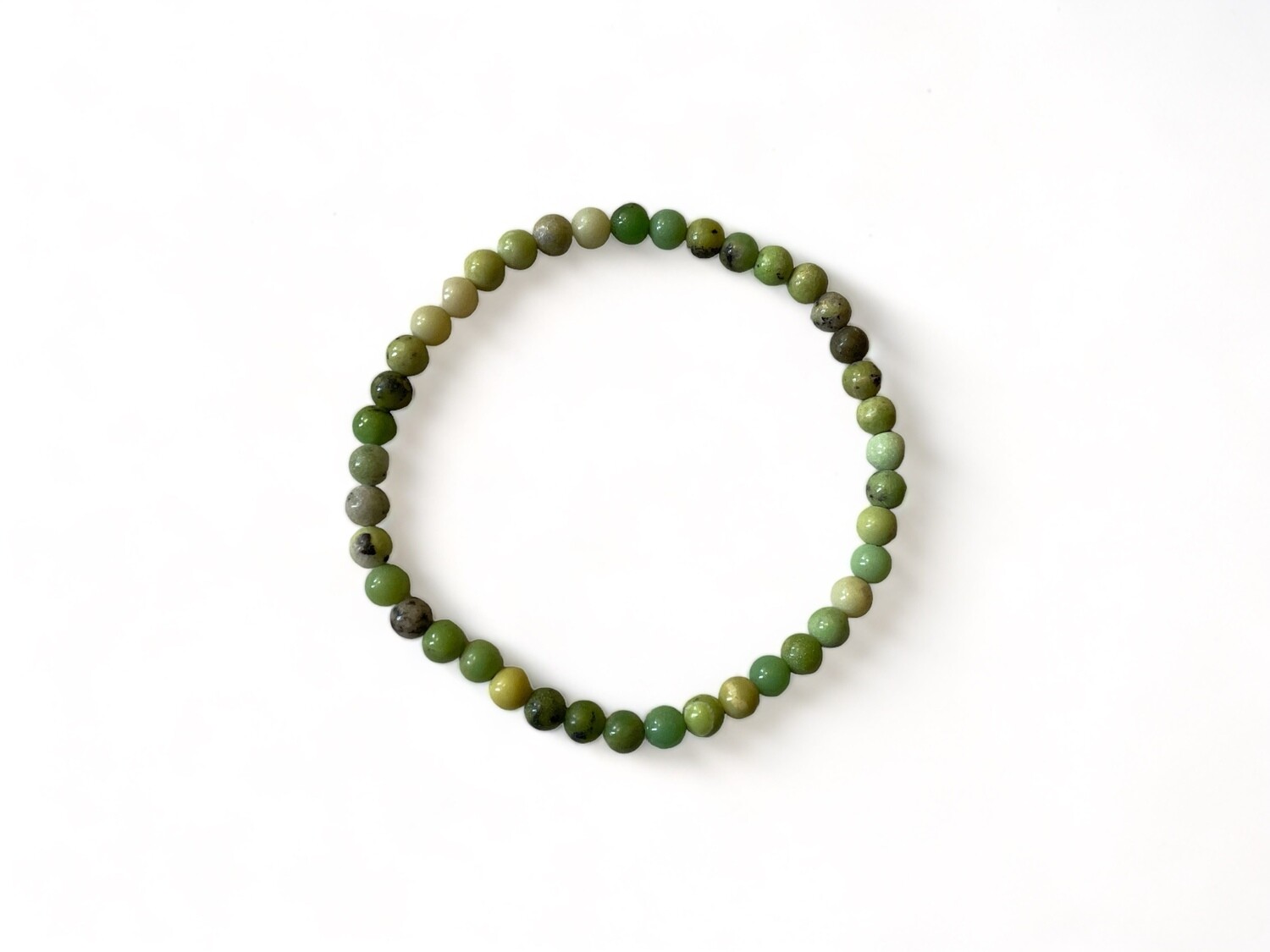 Close-up photo of the Premiere Chrysoprase Bracelet, featuring smooth green beads. This mini bracelet is designed to support emotional healing, creativity, and personal growth.