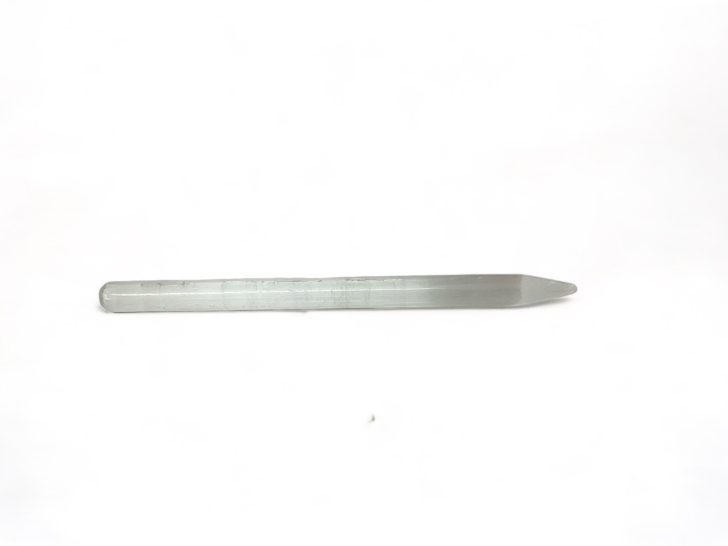 Photo of a Selenite Pencil Wand, ideal for precision energy work and spiritual clarity. Perfect for cleansing, enhancing metaphysical practices, and as a thoughtful gift. Disclaimer: Stone color, size, or shape may slightly vary from image. Each order is randomly chosen by The Crystal Shrine staff.