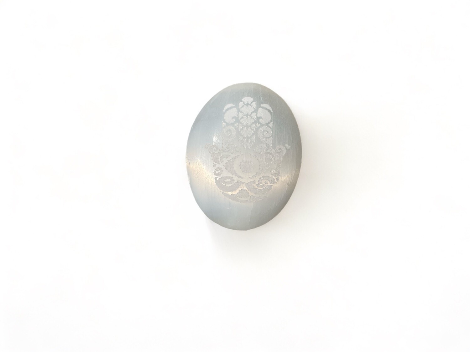 Image of a Selenite Etched Hamsa Palm Stone – Features intricate etching and serves as a powerful tool for energy work and spiritual protection. Available at The Crystal Shrine.