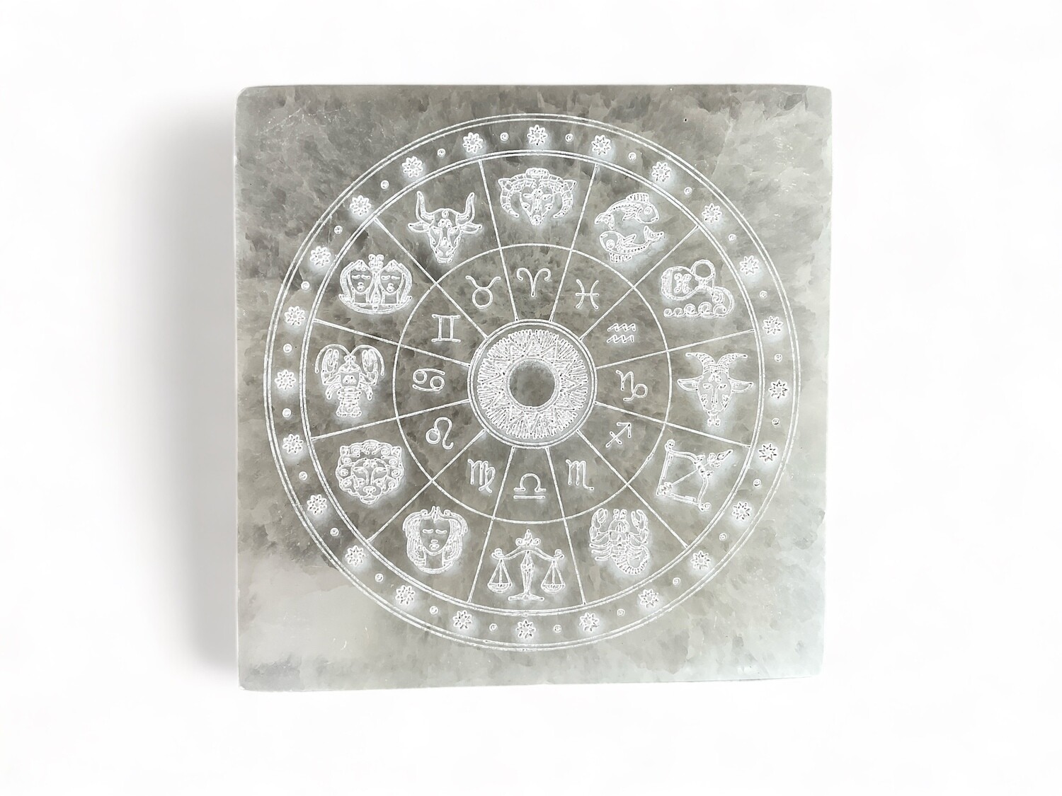 A photo of a Selenite Etched Zodiac Square Plate featuring intricate zodiac symbols. Ideal for astrology lovers and crystal collectors, adding a touch of metaphysical charm.