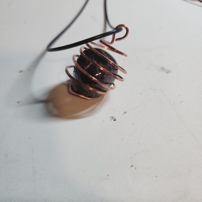 Red garnet stone in copper cage