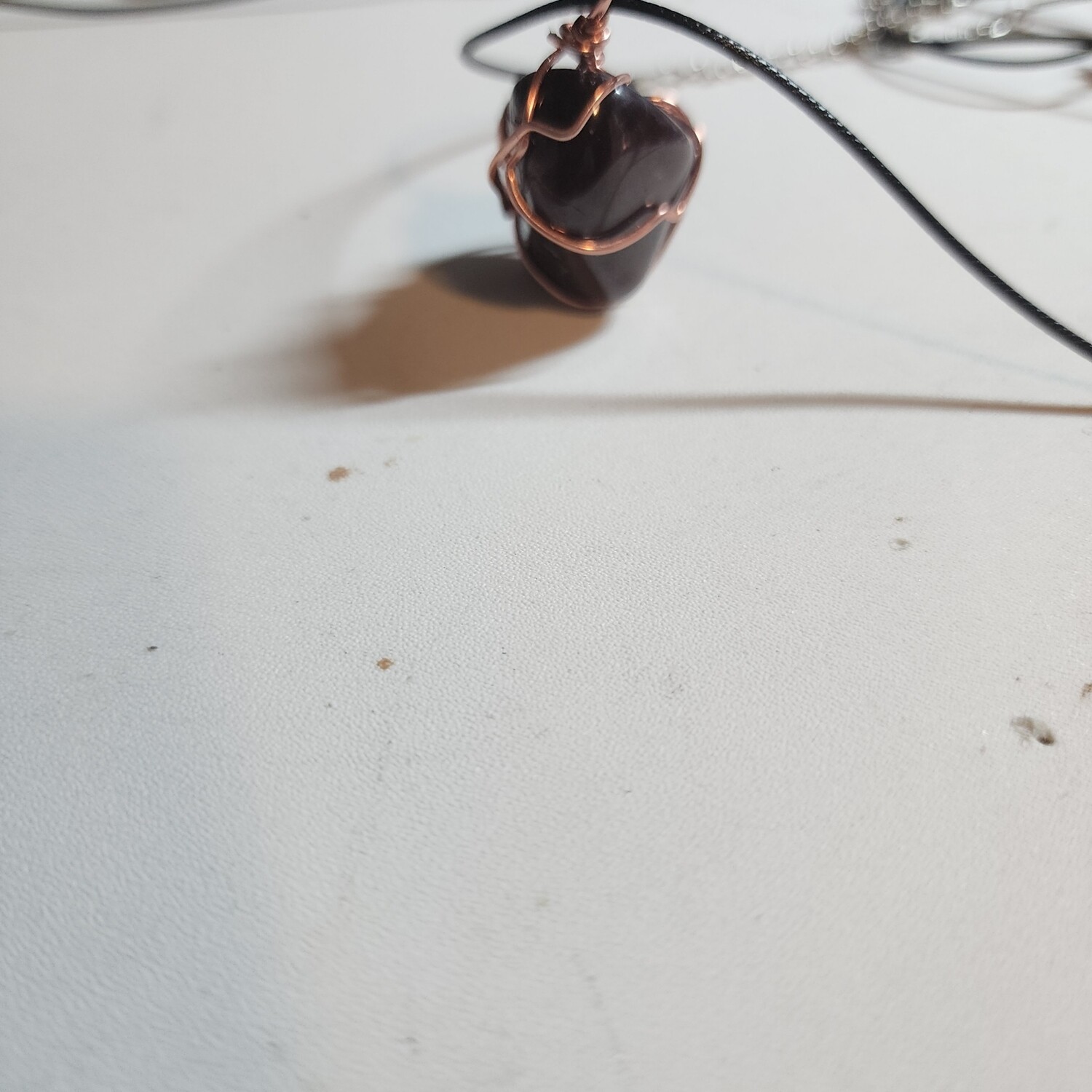 Red garnet stone wrapped in copper wire