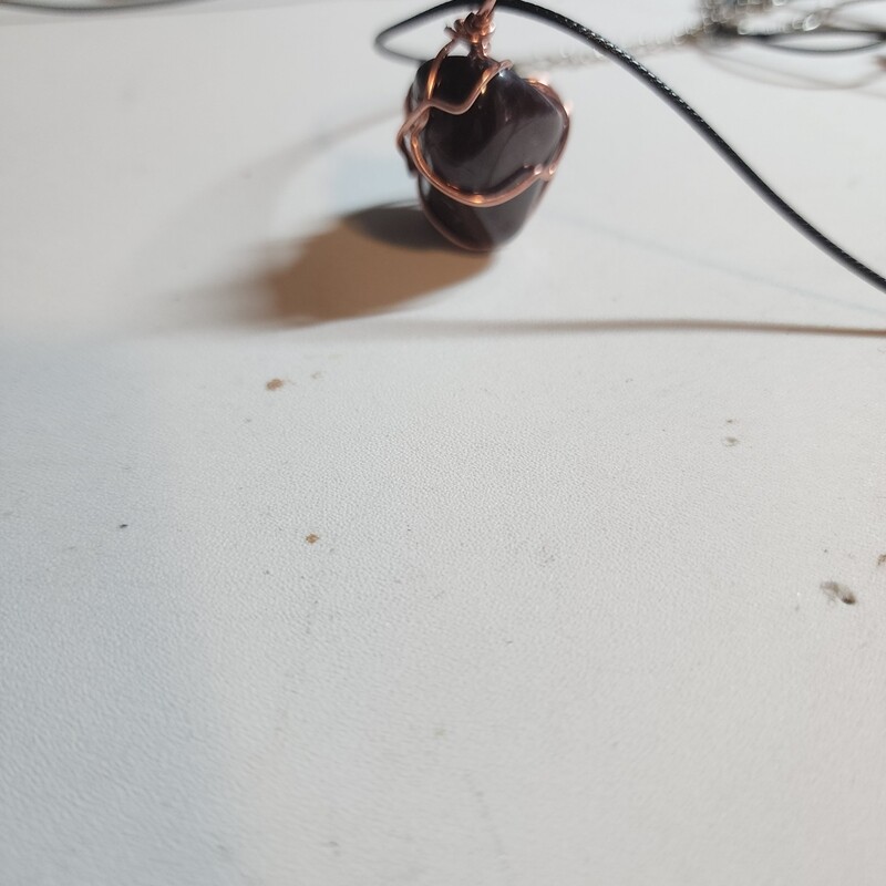 Red garnet stone wrapped in copper wire
