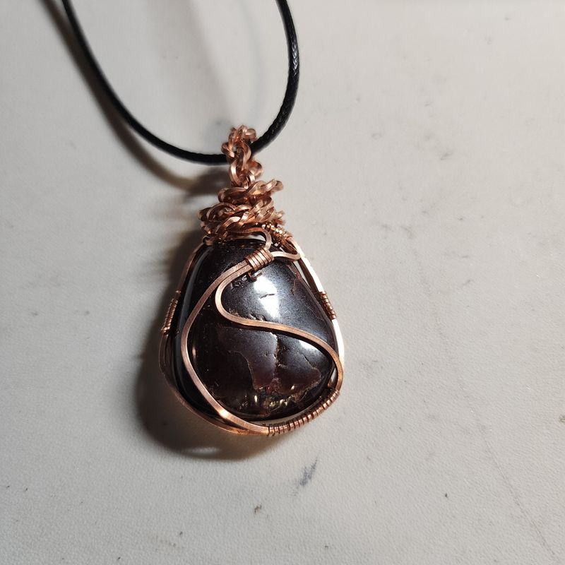 Red garnet stone wrapped in copper wire