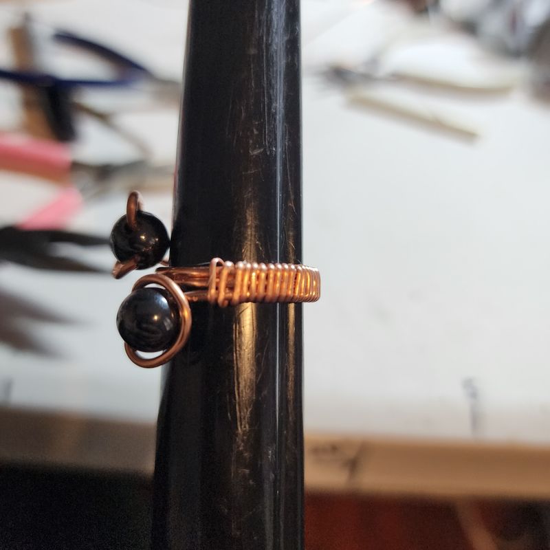 Black hematite ring on copper wire