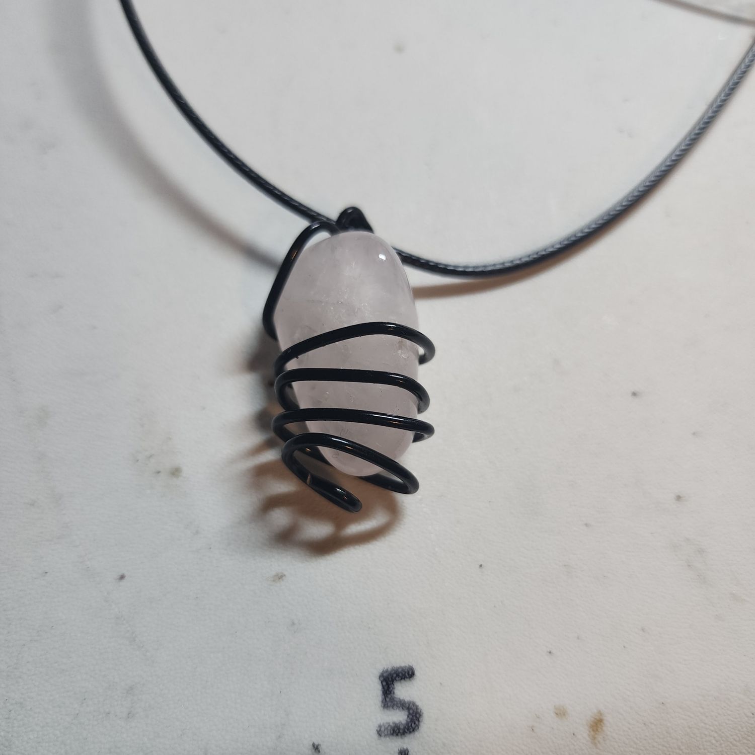 Rose Quartz in black wire cage (small) 