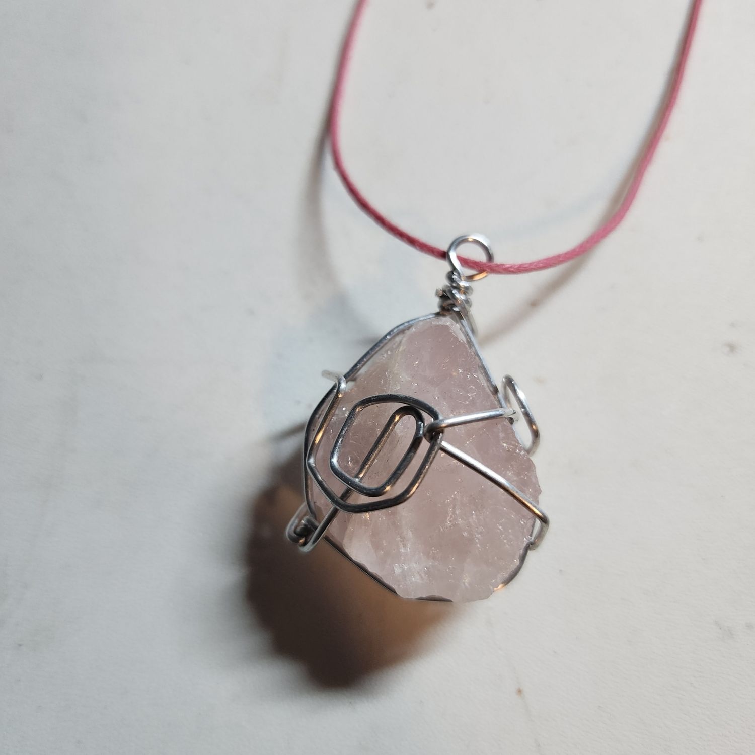 Rose quartz crystal wrapped in silver wire