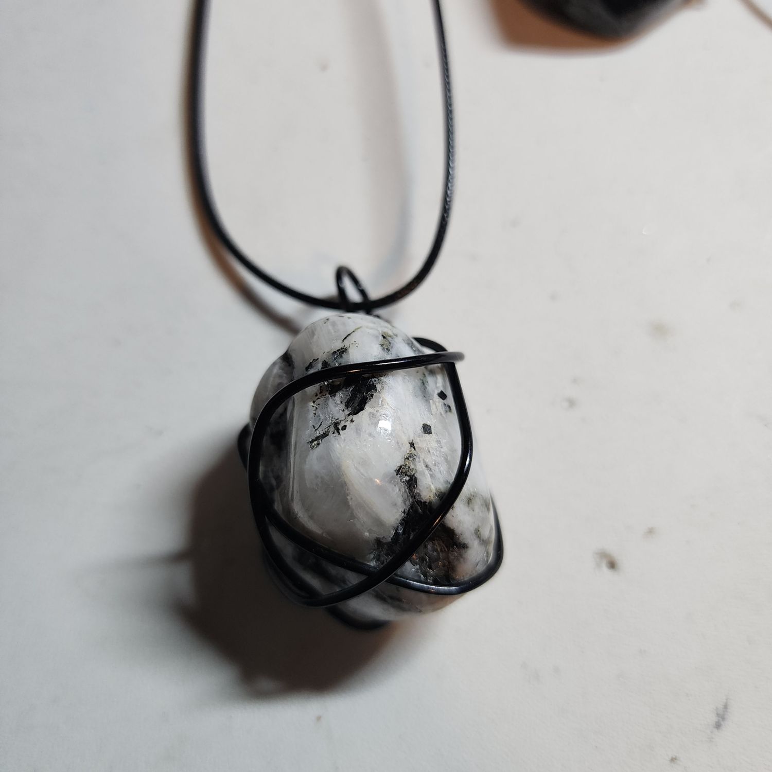 Rainbow moonstone in black wire Rainbow moonstone in black wire