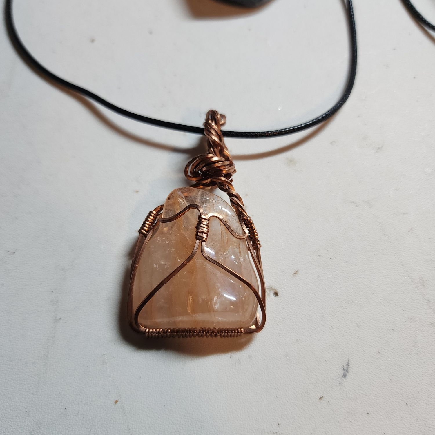 Fire quartz wrapped in copper wire Fire quartz wrapped in copper wire