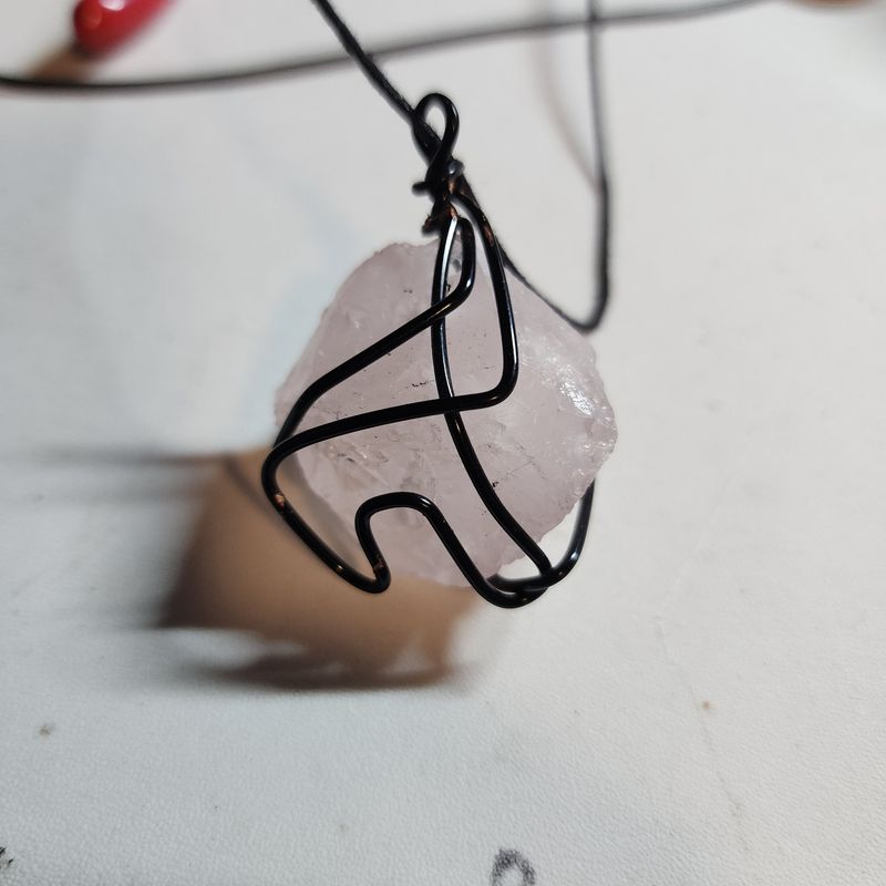 Rose quartz crystal wrapped in black wire