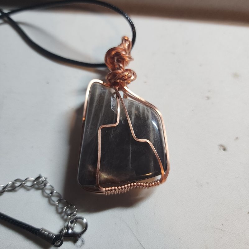 Black moonstone wrapped in copper wire
