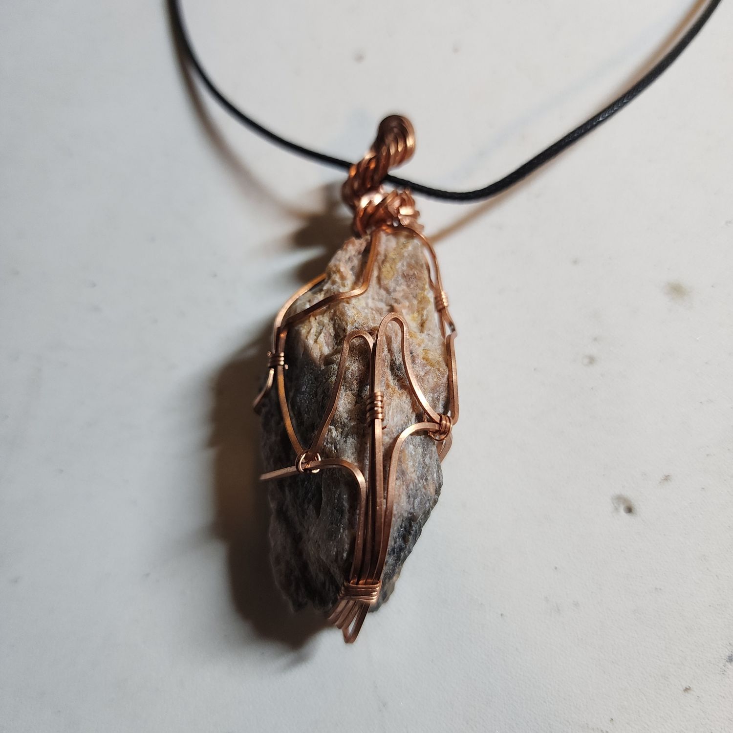 Rough black moonstone wrapped in copper wire Rough black moonstone wrapped in copper wire