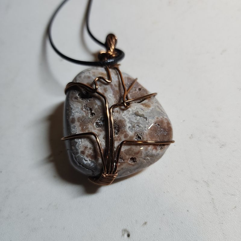 Crazy lace agate polished stone wrapped in copper wire