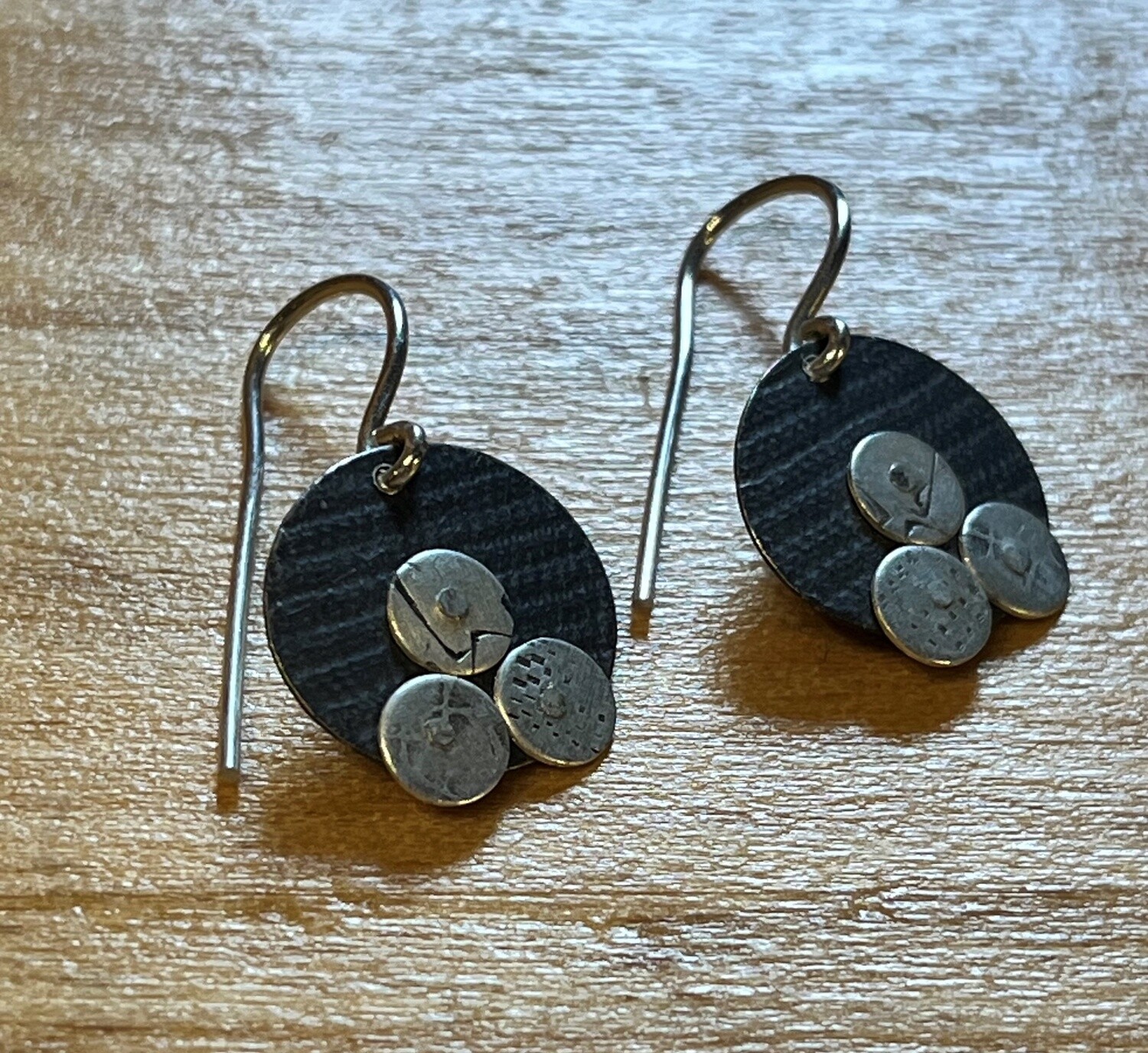 Bent Metal Ear Three Coins on Disc