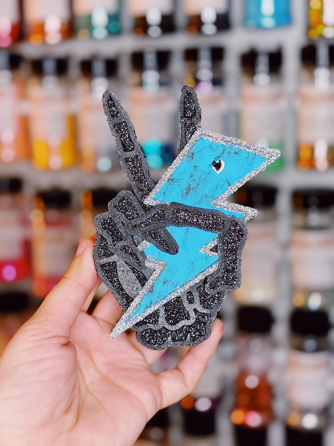 Skeleton hand with turquoise bolt