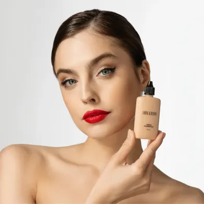 Close-up of LORD &amp; BERRY Cream Foundation in a stylish 50ml bottle, showcased alongside a model with a flawless complexion. The creamy formula offers smooth application and natural coverage, perfect for all-day wear. Explore premium makeup products at mygeishamiltonkeynes.co.uk. #LORDandBERRY #CreamFoundation #Makeup&quot;