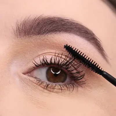 Close-up of a woman&#39;s eye as LORD &amp; BERRY mascara is applied to her lashes, highlighting volume, length, and precision. The image emphasizes the product&#39;s ability to enhance natural beauty, making it ideal for beauty tutorials and premium cosmetic promotions. Explore the LORD &amp; BERRY collection at mygeishamiltonkeynes.co.uk. #LORDandBERRY #Mascara #EyeMakeup
