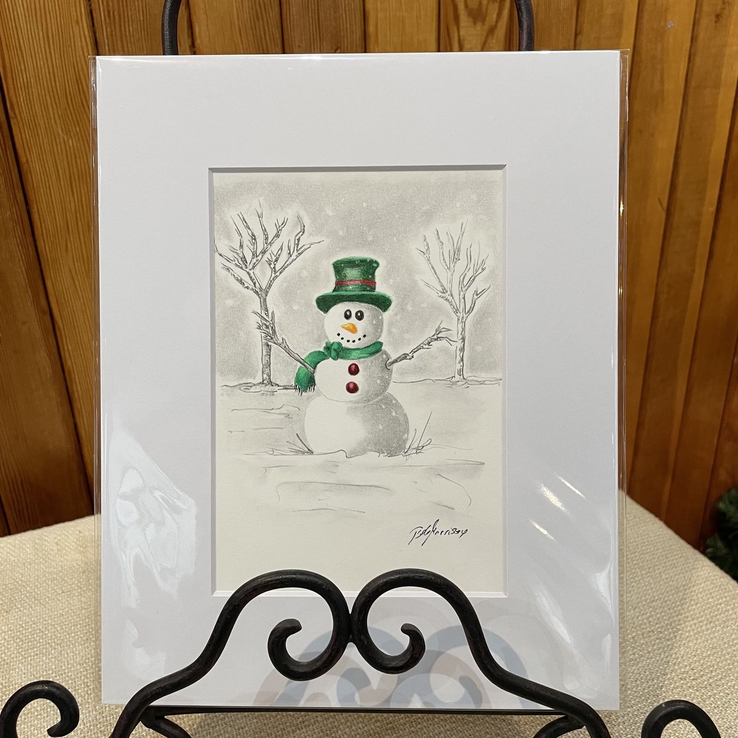 Snowman with green hat and scarf