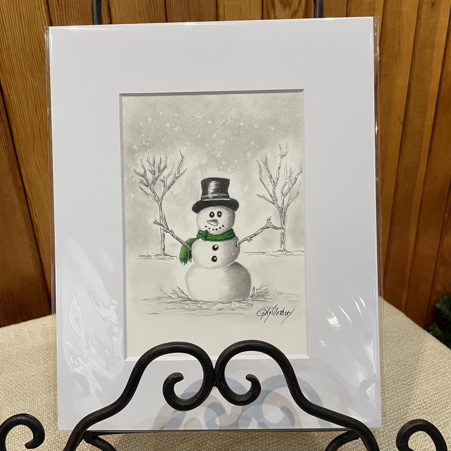 Little snowman with green scarf
