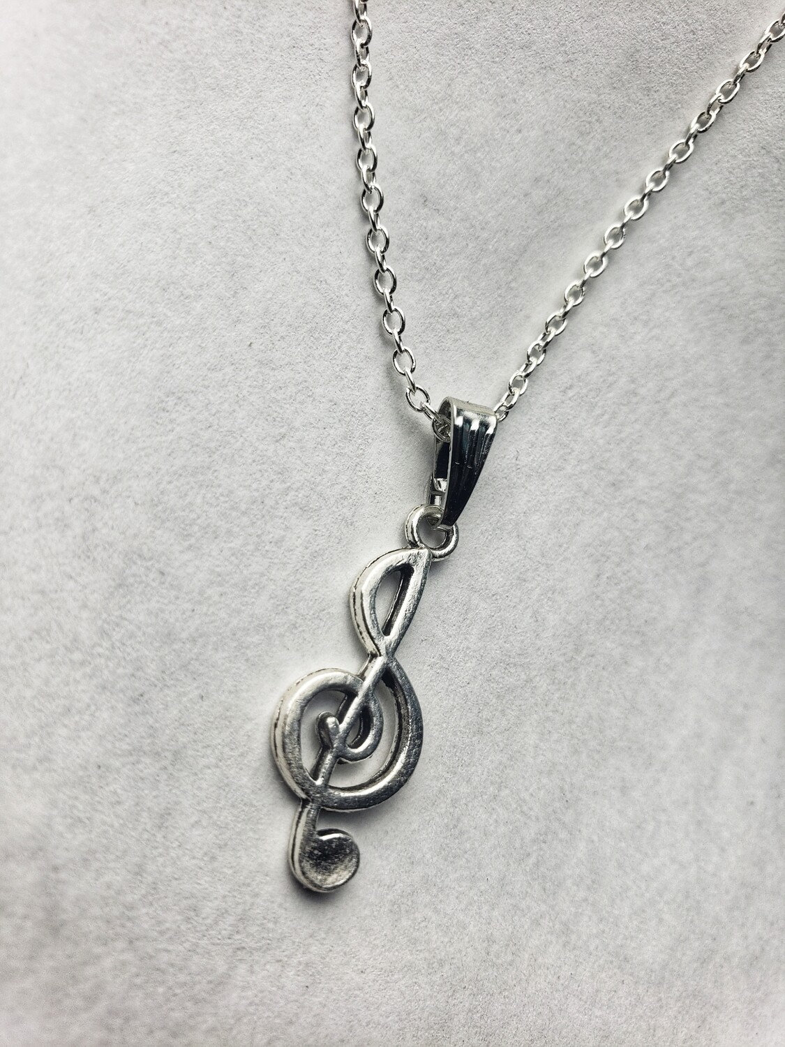 silver necklace with music pendant