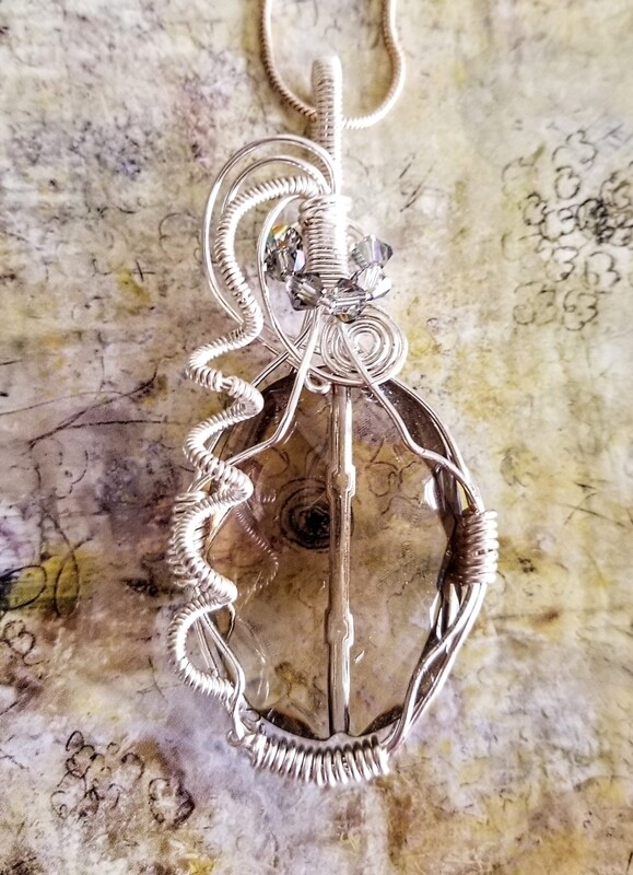 Multi Faceted Smokey Quartz Pendant with Swarovski Crystal Accents. Comes with Sterling Silver, 22" chain.