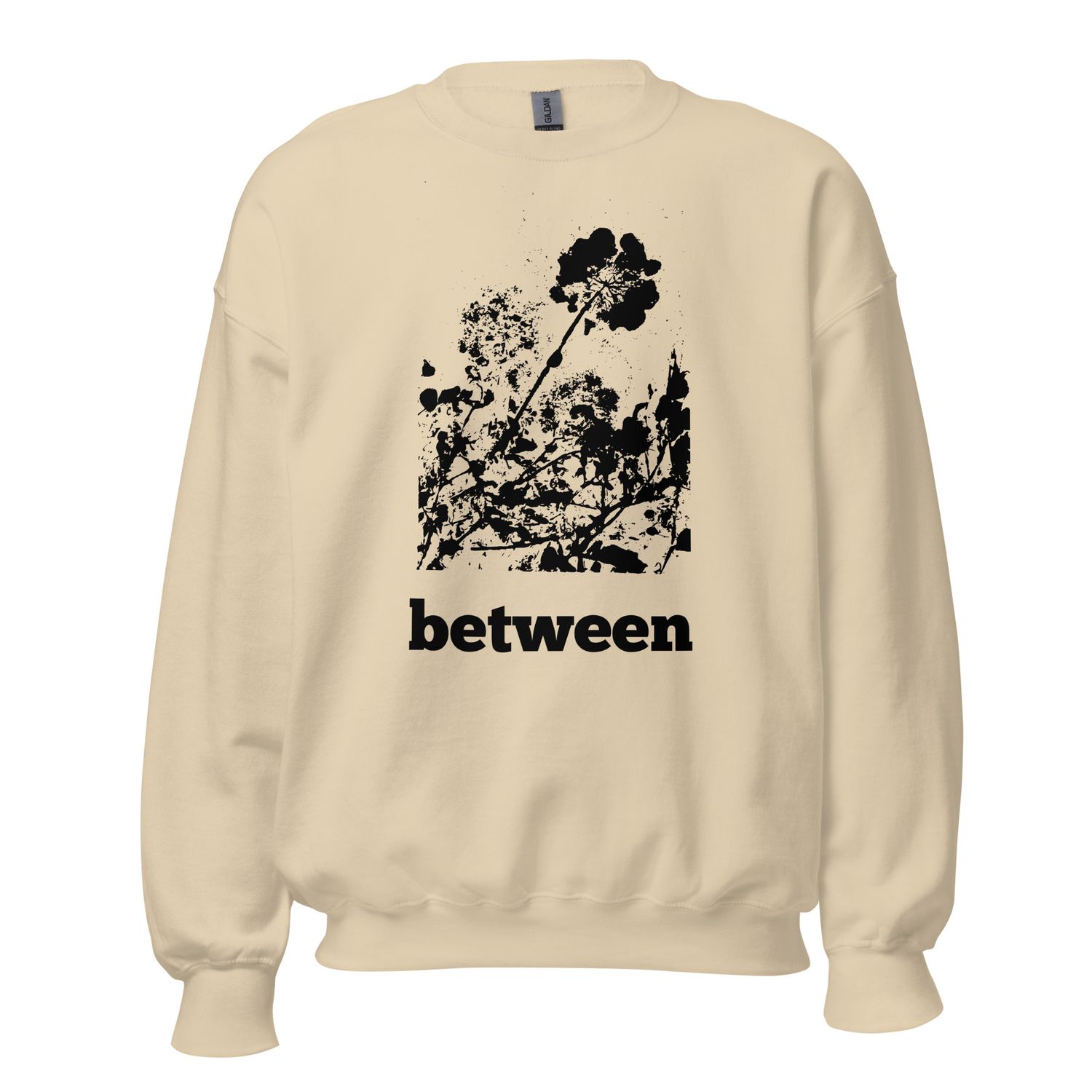 Close-up of Between floral impression artwork on sweatshirt | Sand with black floral imprint | Front side