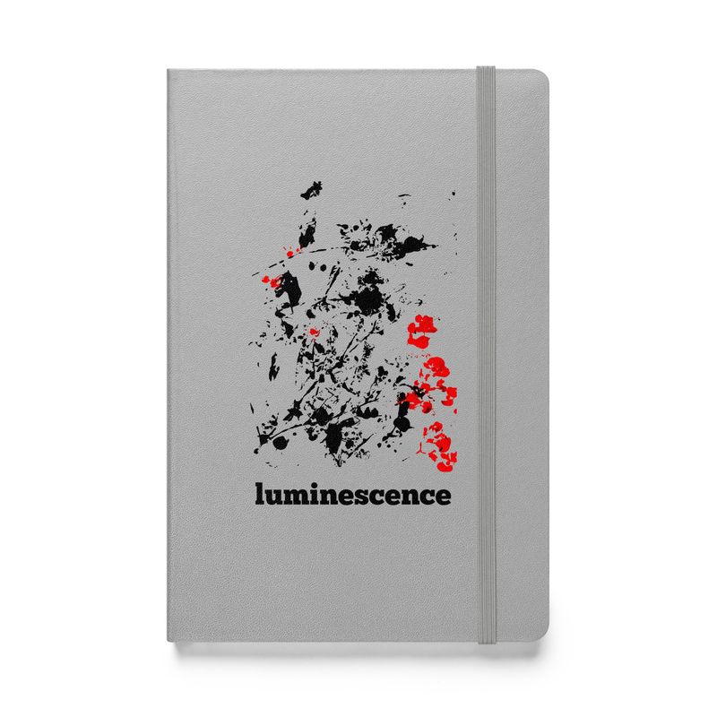 Luminescence - Artist designed Hard cover notebook front view. Silver color with black and red design print.