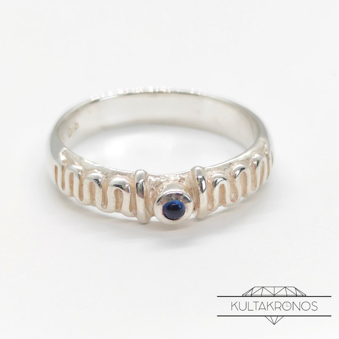 Hopeasormus sinisellä kivellä