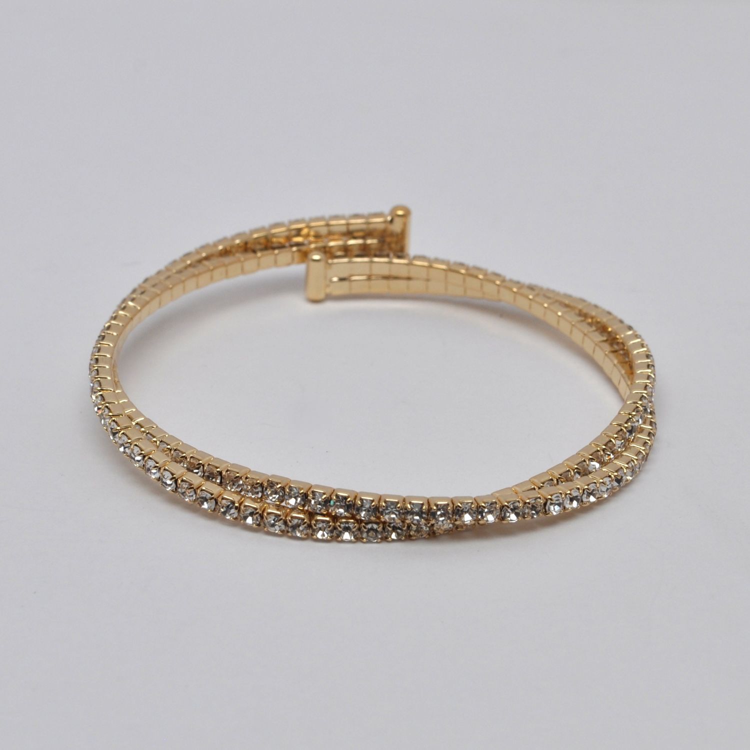 J83487B1G CLR/G  2 LINE TWSTD CUFF BRAC