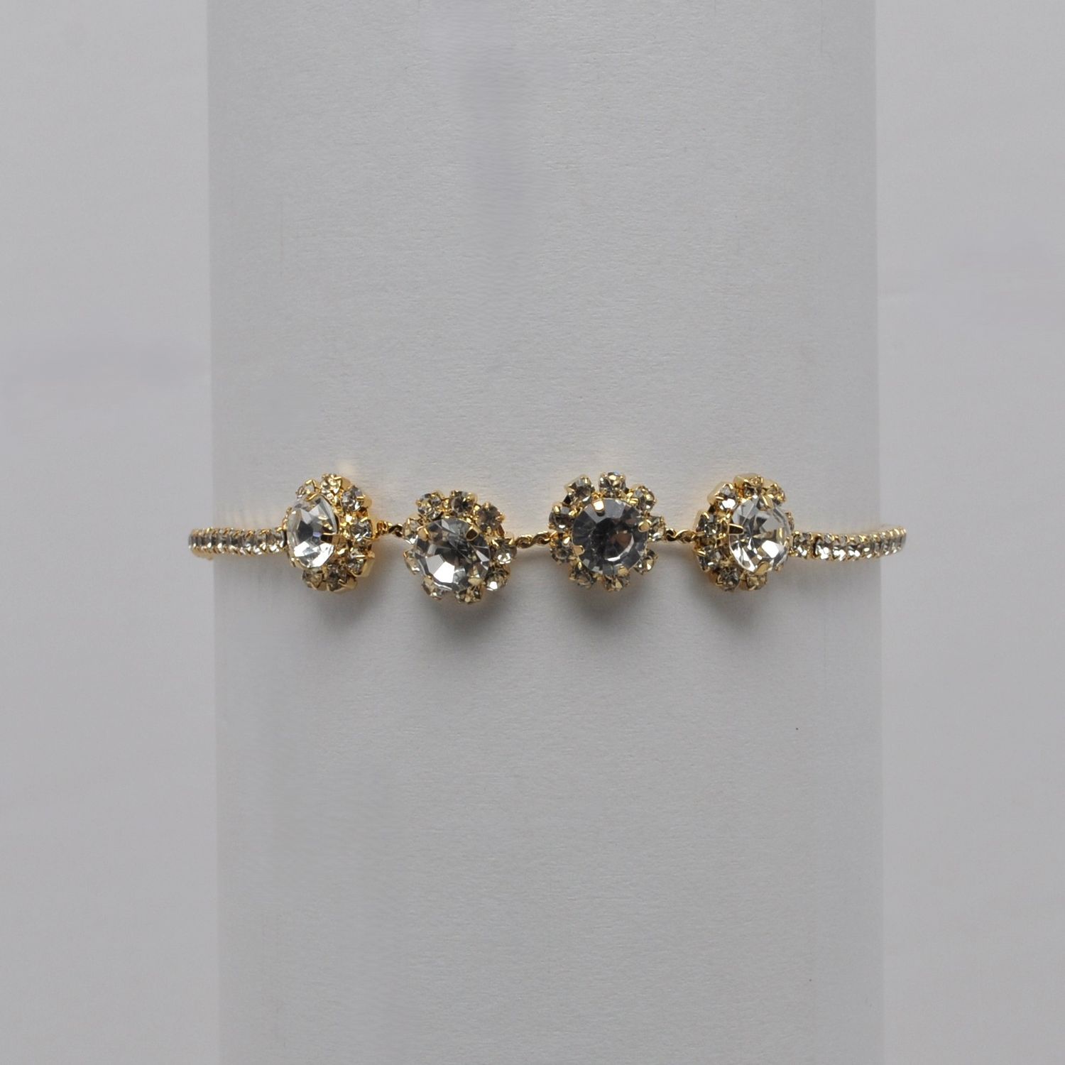 J84635B1G CRY/GLD 4 FLOWER SLIDE BRACELET
