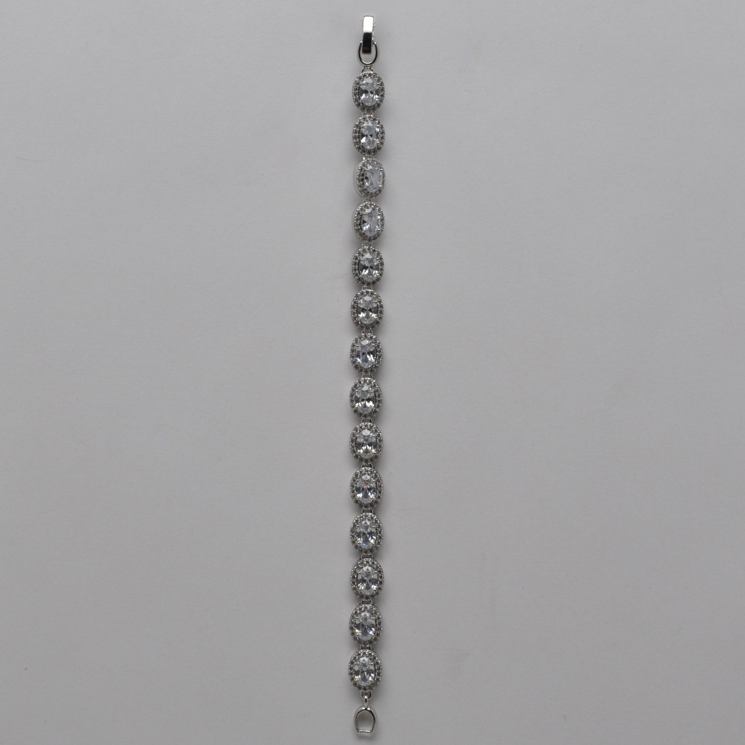 CN004500B1S CZ SIDEWAYS OVAL STONE W' CRY TRIM BRACELET