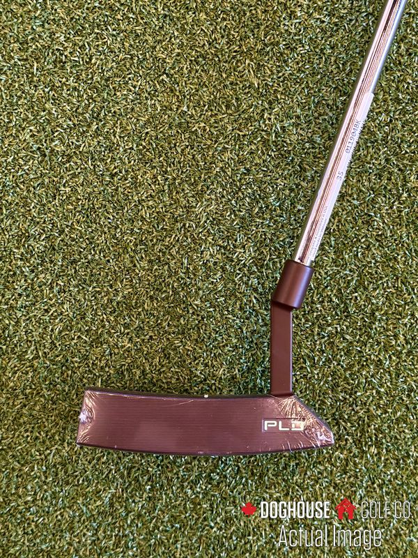 ping pld milled putter on golf turf, showing the face of the putter