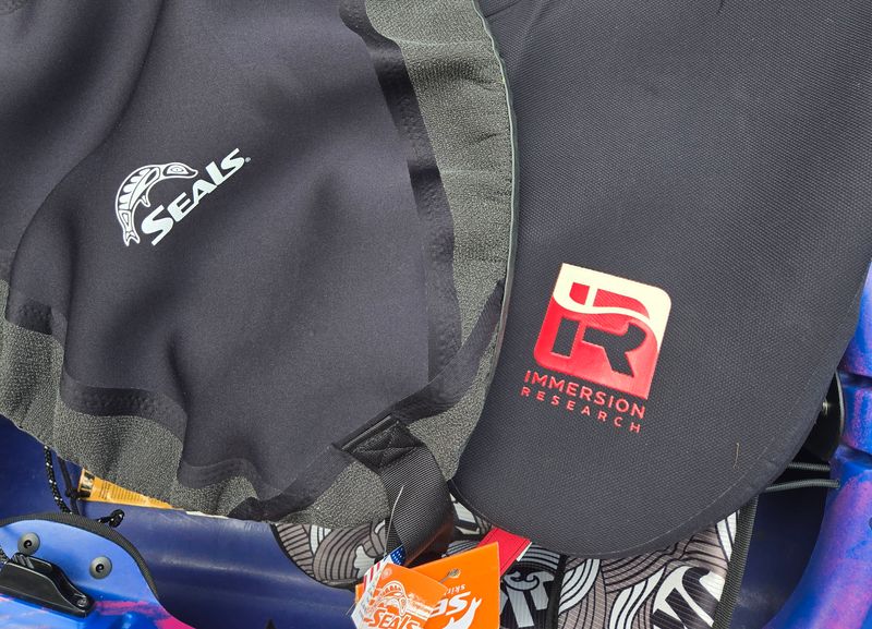A Seals Pro Rand and Immersion Research Klingon Empire Whitewater Spray Skirt sitting on a kayak.