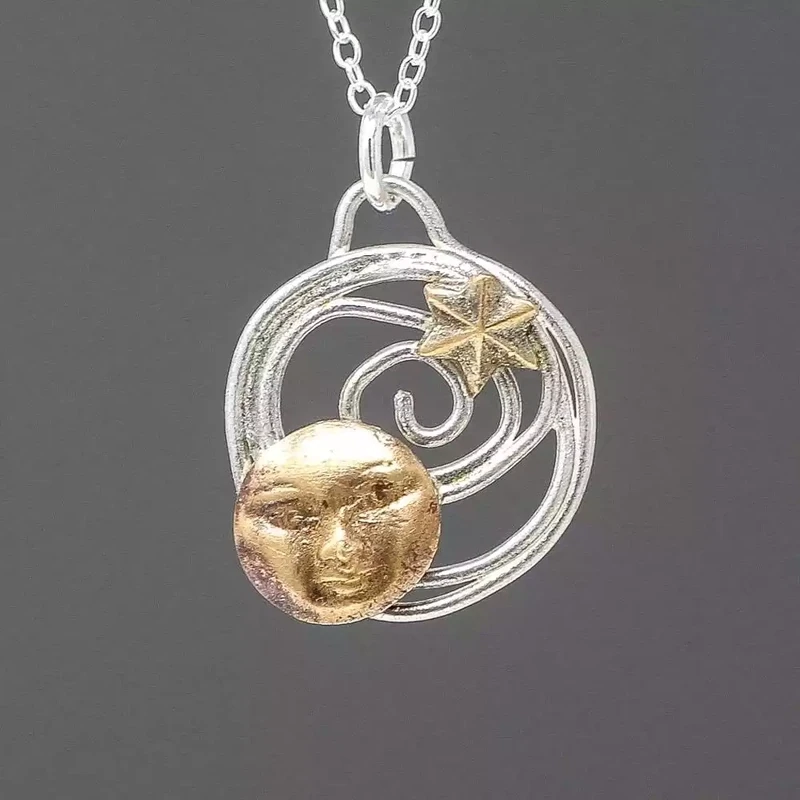 Moon and Star Bronze and Silver Pendant by Xuella Arnold