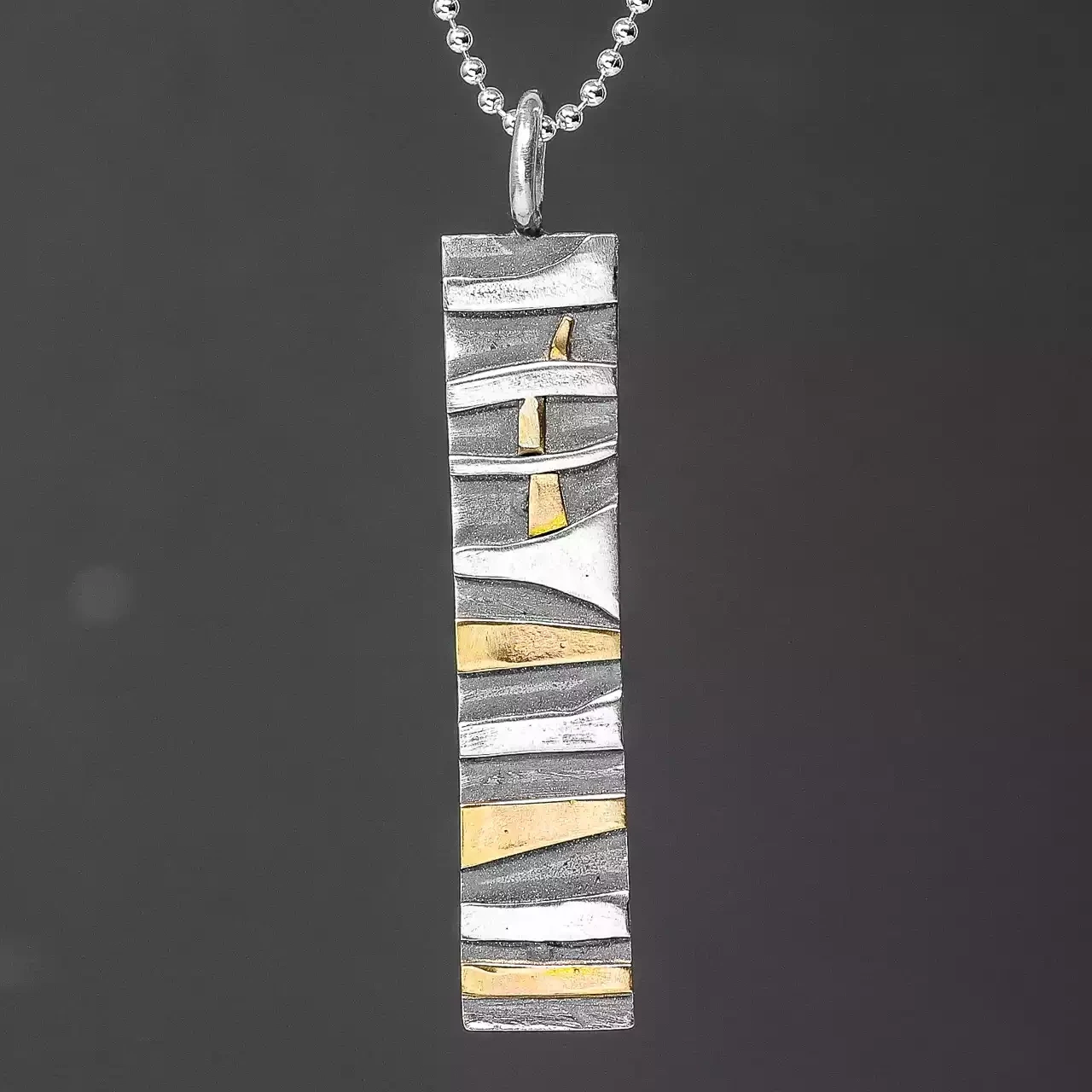 textured silver with gold rectangular pendant by adele taylor
