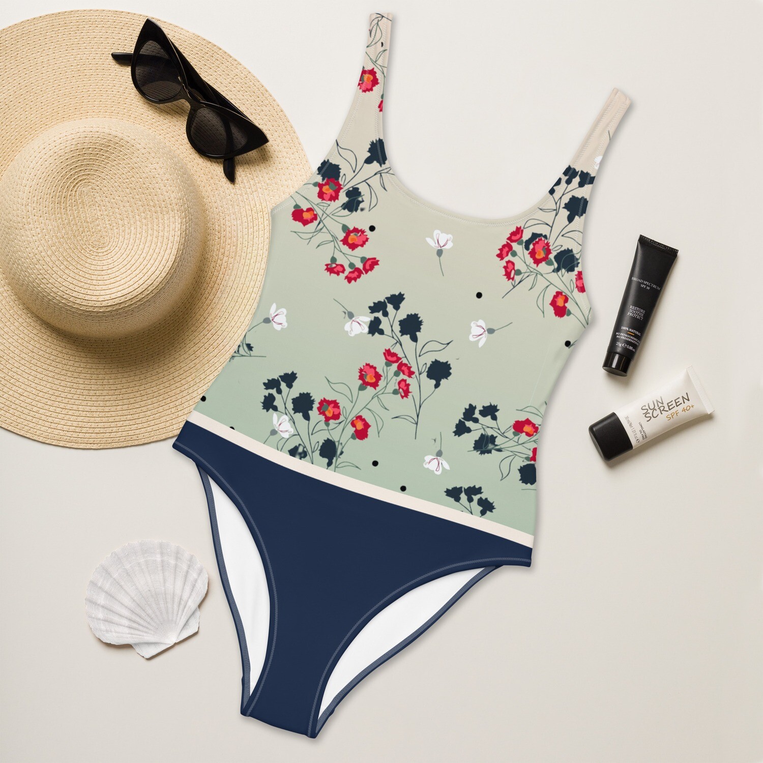 Navy blue swimsuit with meadow pattern and pastel green details on the front in sizes XS-3XL