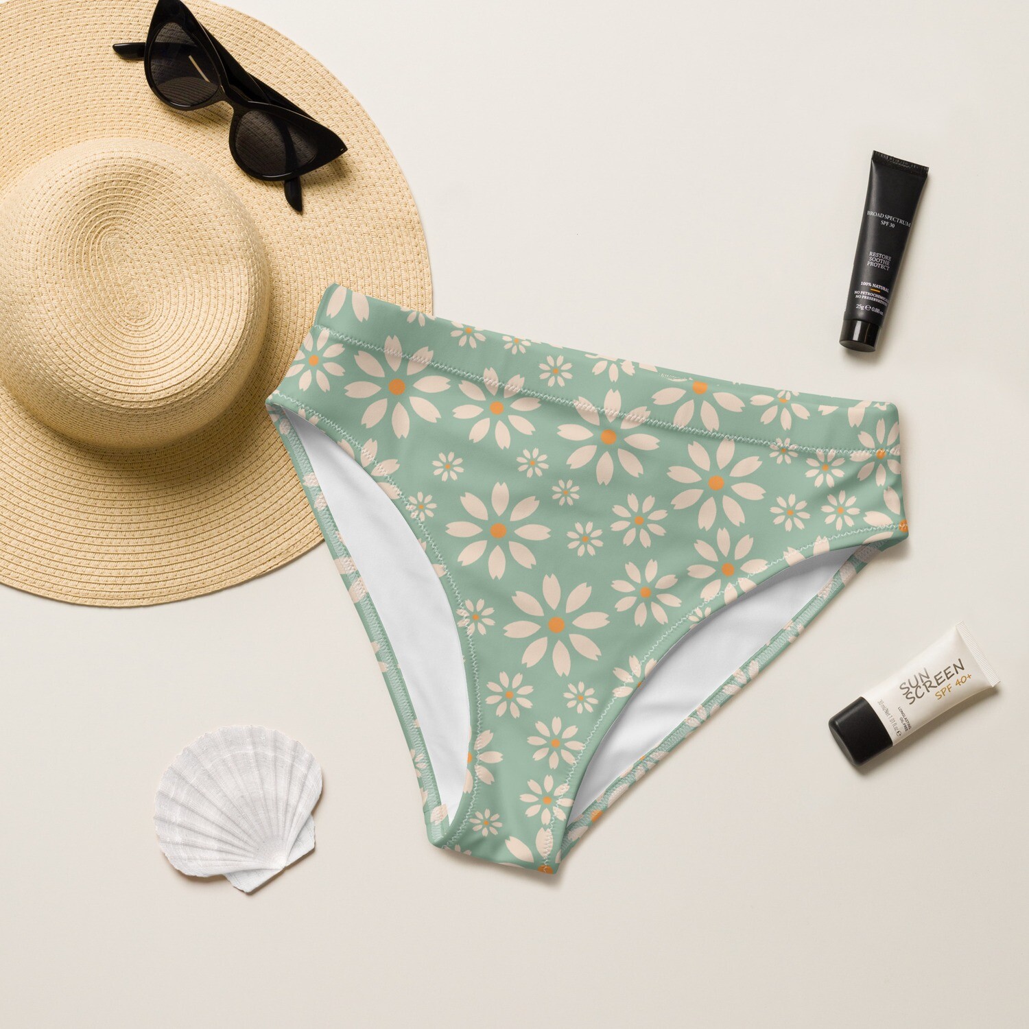 Pastel green recycled high-waisted bikini bottoms with daisies and white lining in sizes XS-3XL